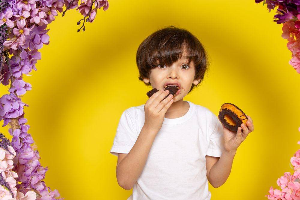 boy eating choco donuts