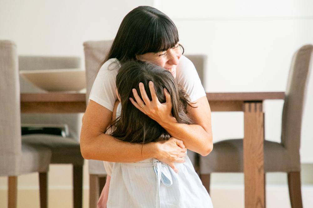 mother embracing her daughter
