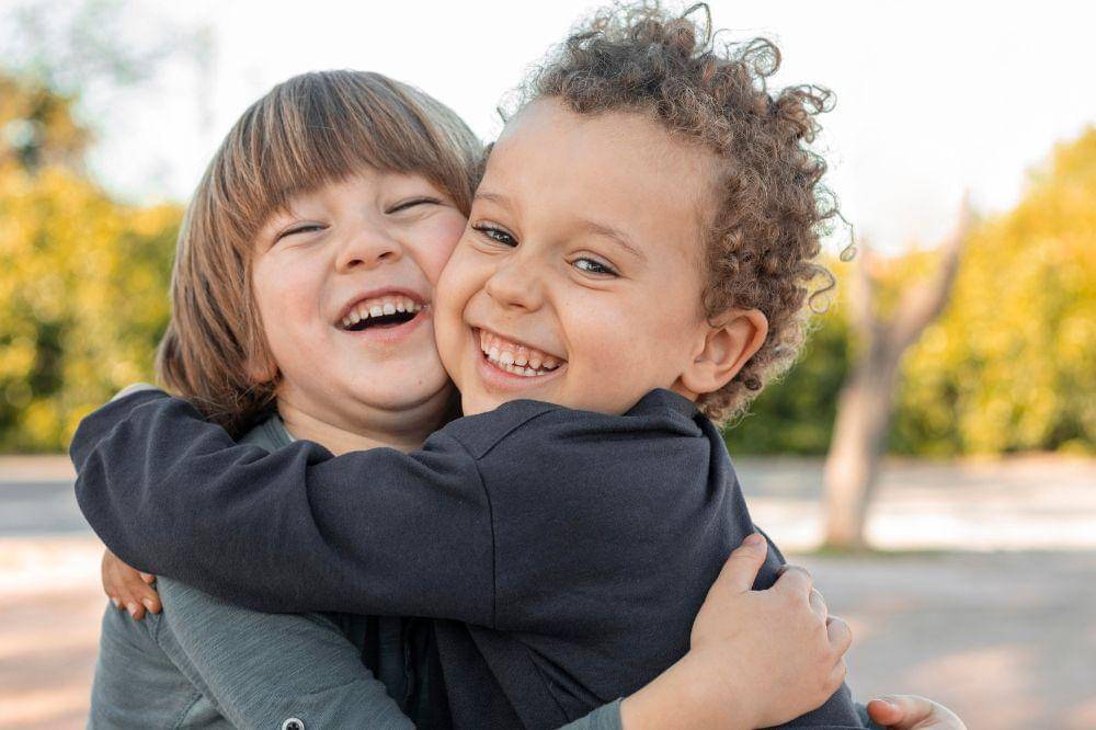 Little boys outdoors hugging