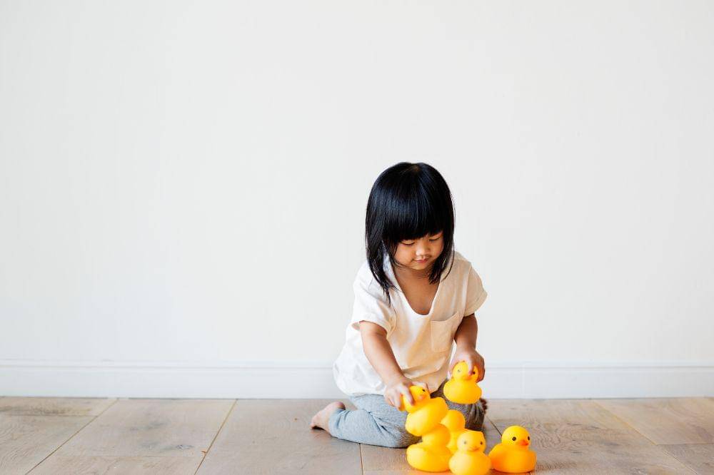 Young asian girl playing alone