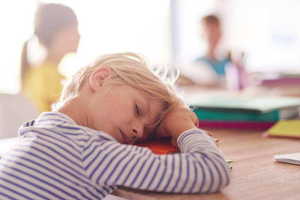 Sleepy boy in the classroom