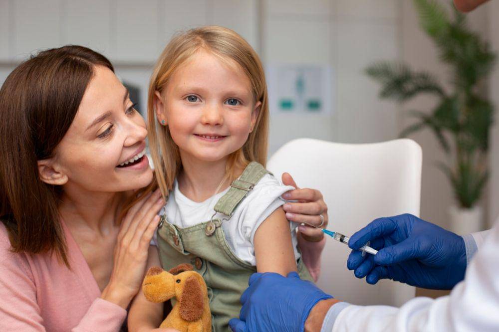 mother with her daughter at the pediatrician for a vaccine