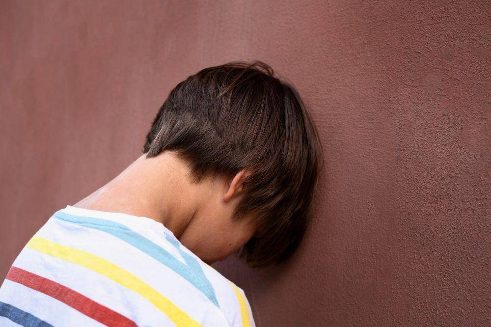 Side view sad kid near wall
