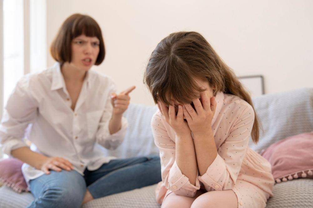 upset mother scolding daughter