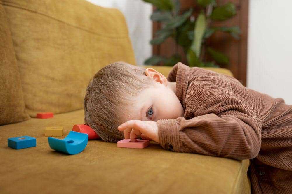 kid laying on couch