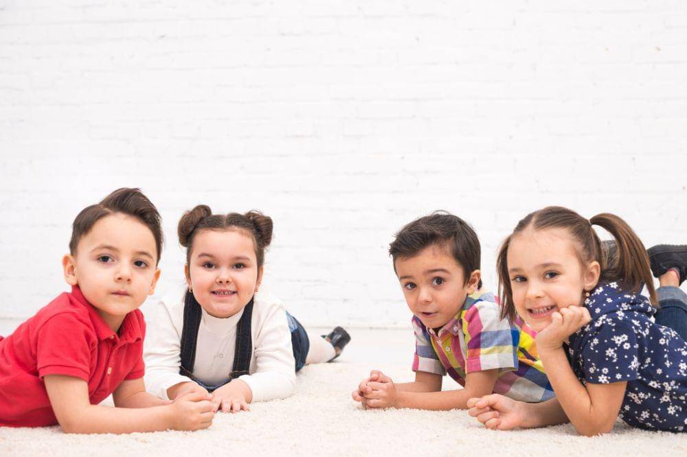 Smiling children lying down