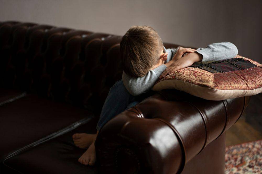 A boy cover his face