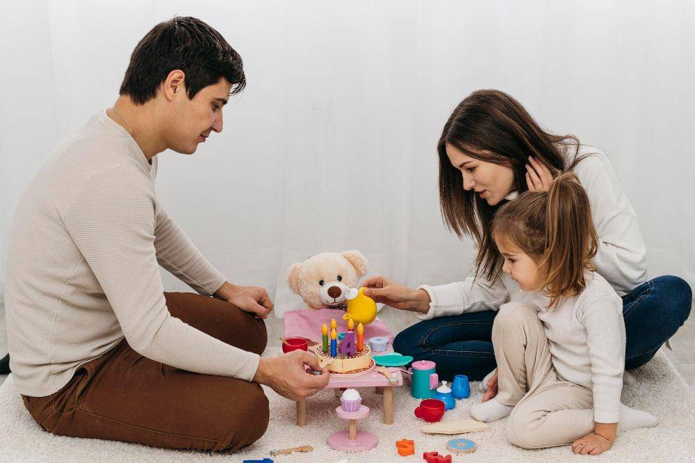 Mother and father playing with daughter