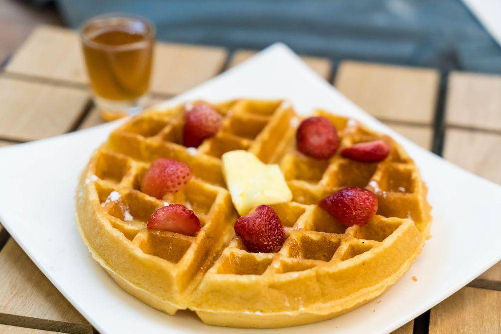 Butter waffle with honey and strawberry