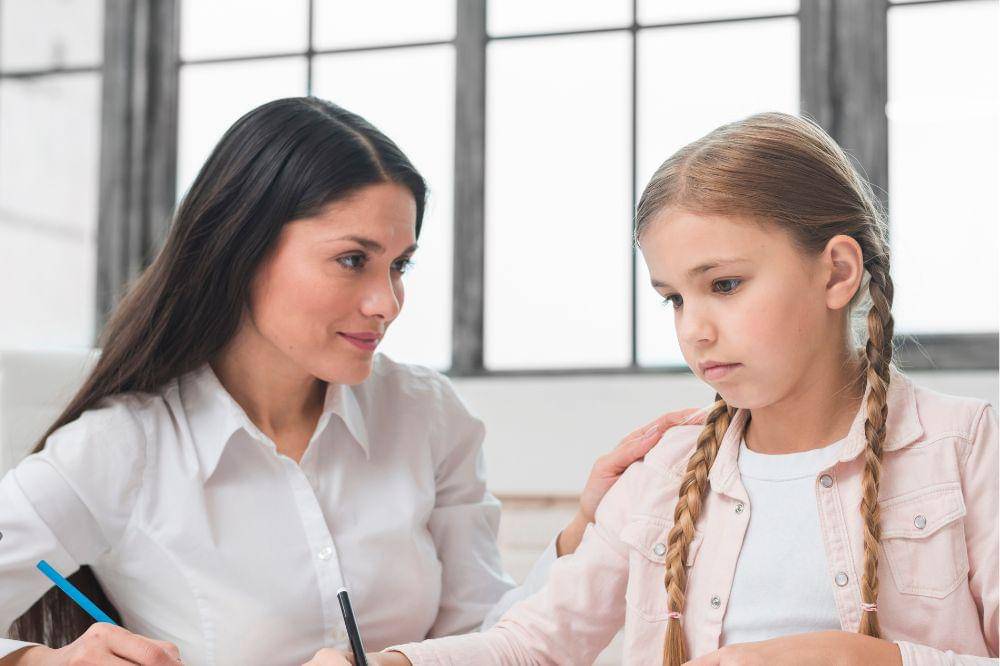 A woman looking at sad girl