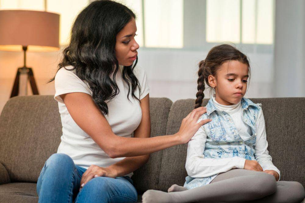 Mom comforting her upset daughter