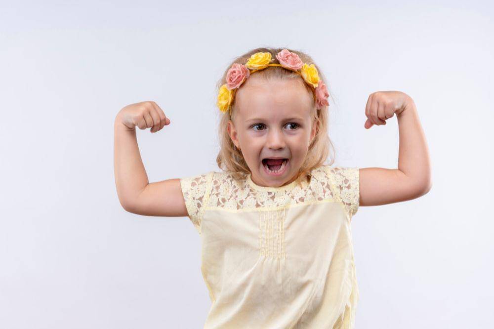 little girl showing her muscles