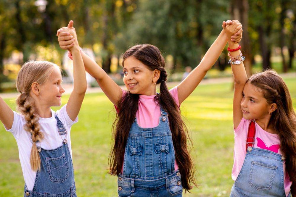 Little girls holding hands in the air