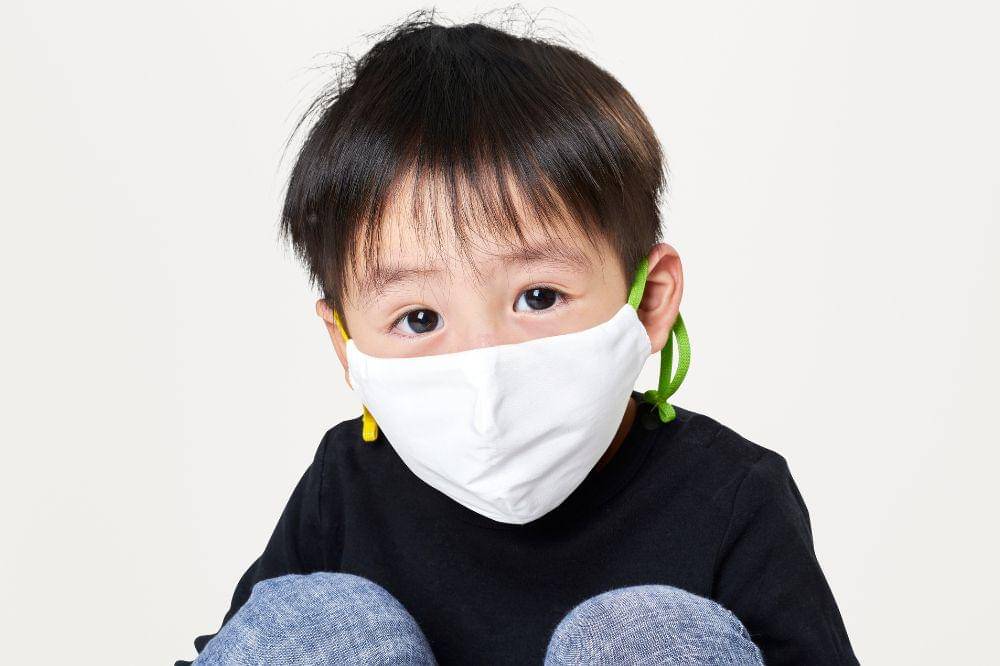 Boy wearing white face mask