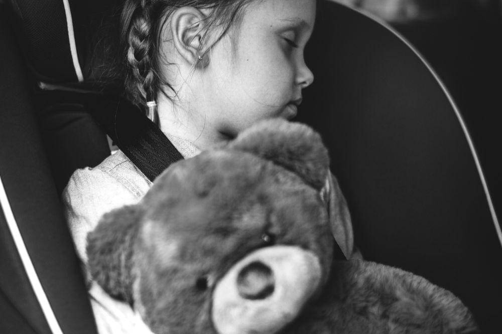 Little girl sleeping in the car