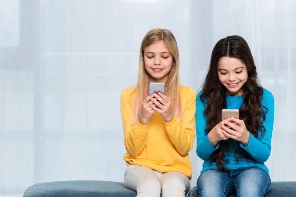 Copy-space girl using mobiles