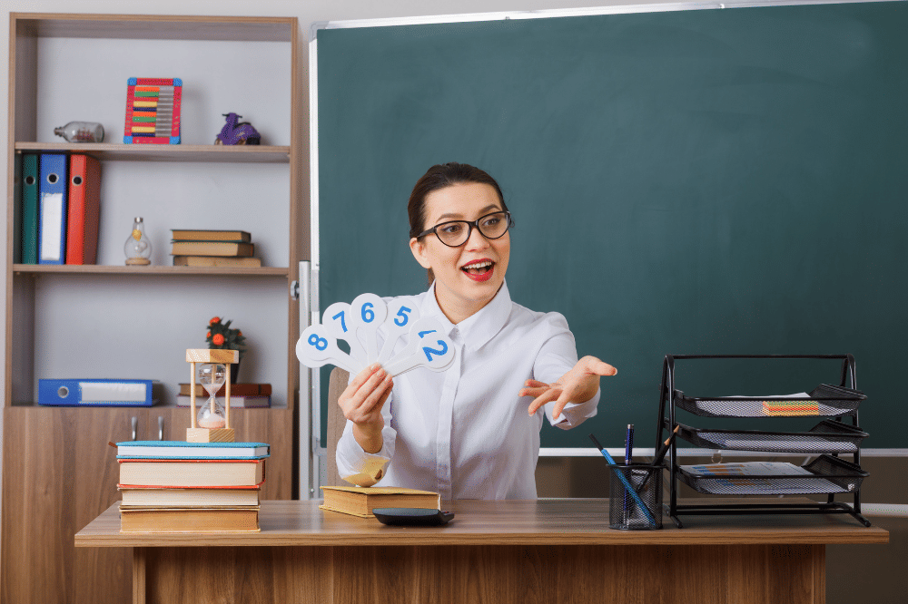 Guru sedang duduk dan mengajuka pertanyaan pada siswa
