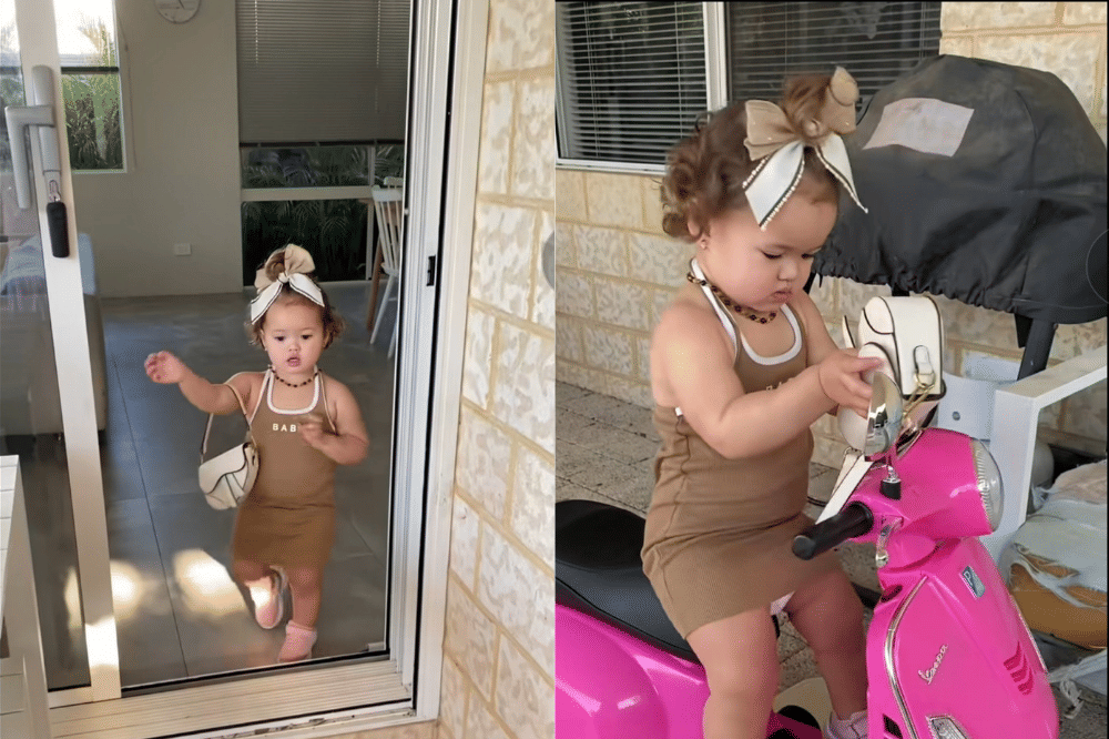 Briella memakai dress coklat dengan pita rambut senada