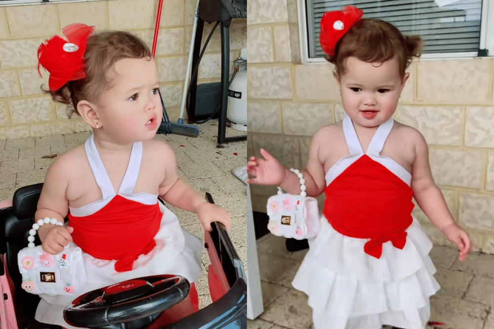 Briella memakai dress merah-putih model halter neck yang ceria