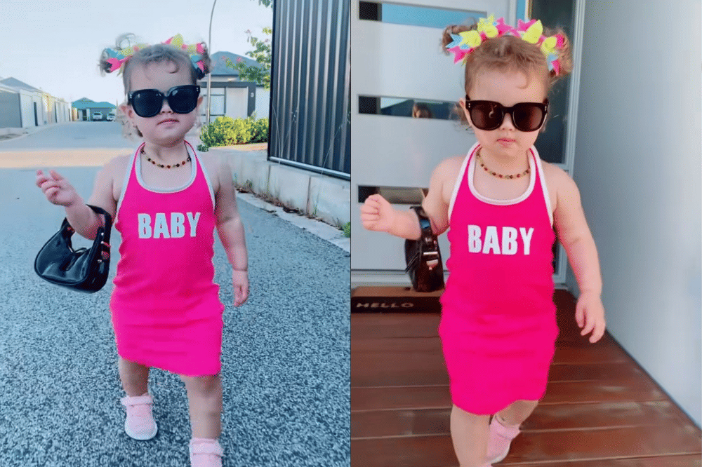 Briella memakai dress magenta bertuliskan “baby” dan aksesori warna-warni