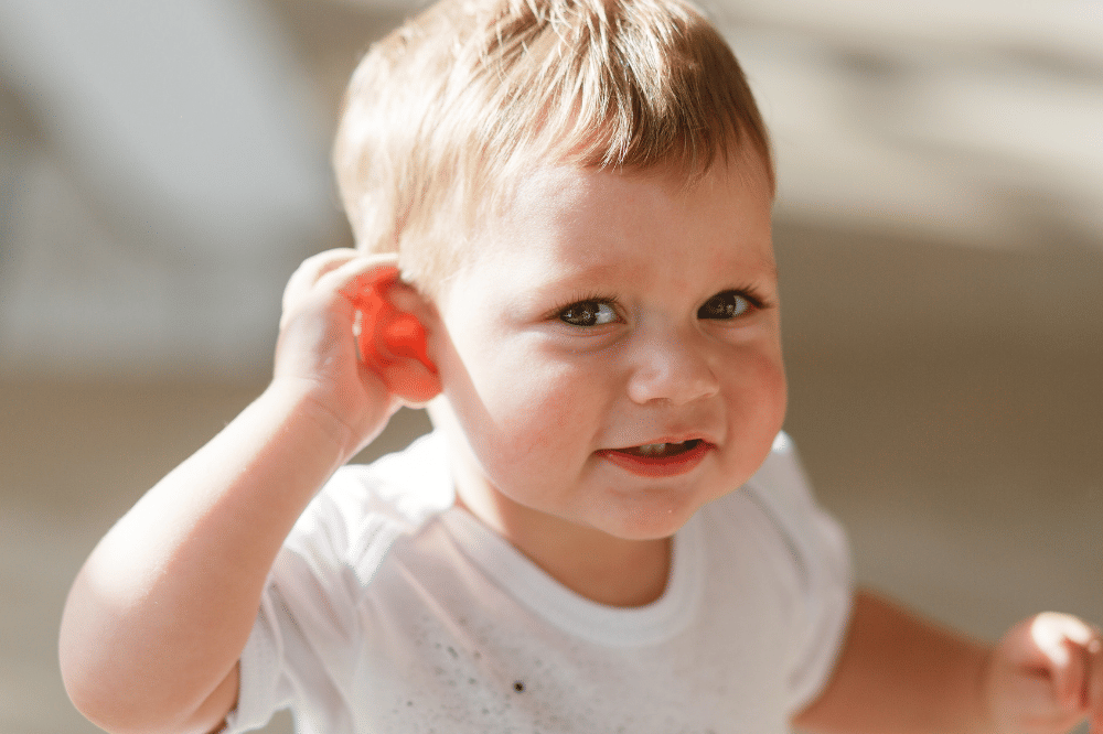 anak memegang telinga
