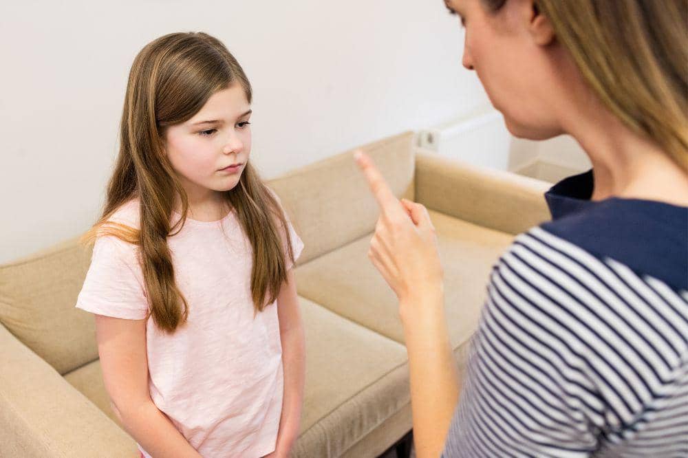 mother scolding his daughter