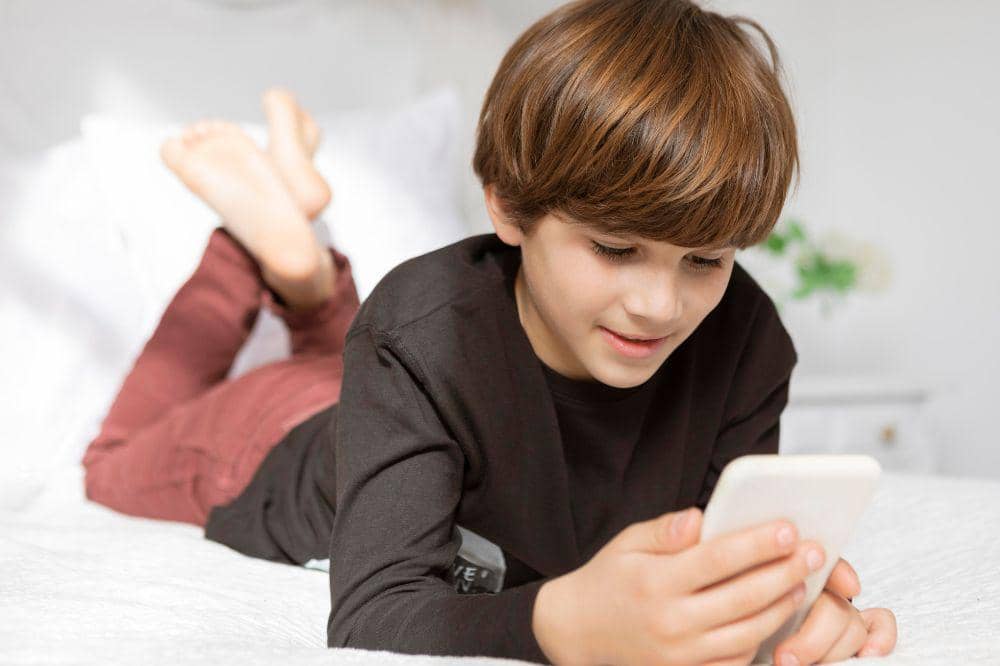 young kid playing phone