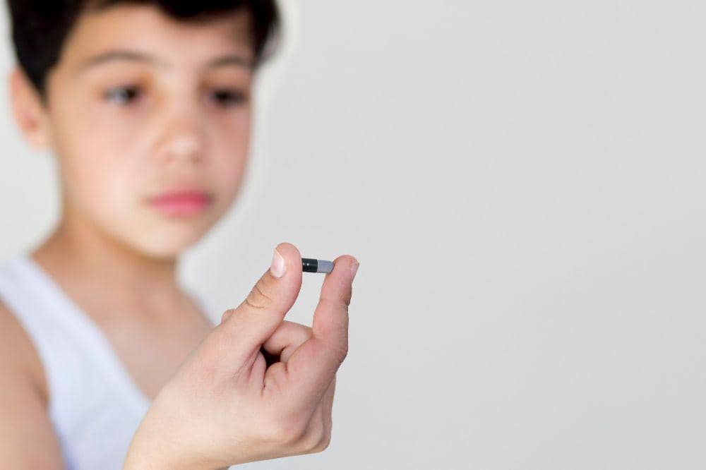 Copy-space little boy with pill