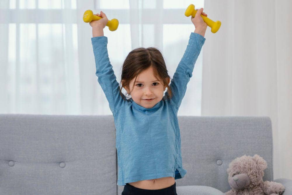 Full shot girl holding dumbbells