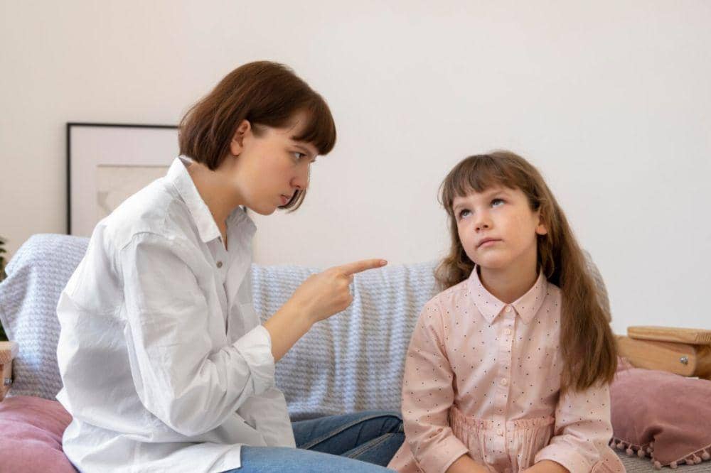 Medium shot mother scolding girl