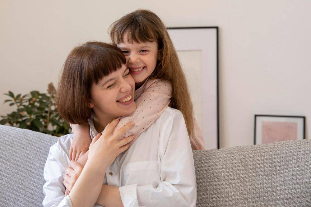 Medium shot happy woman and girl.jpg