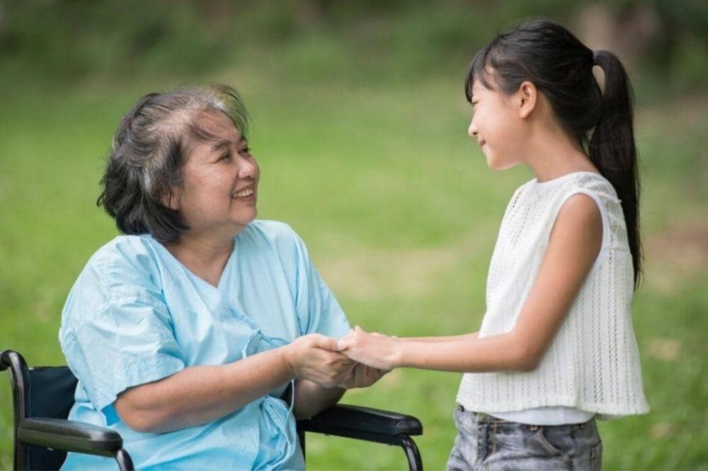 Anak perempuan memegang tangan nenek