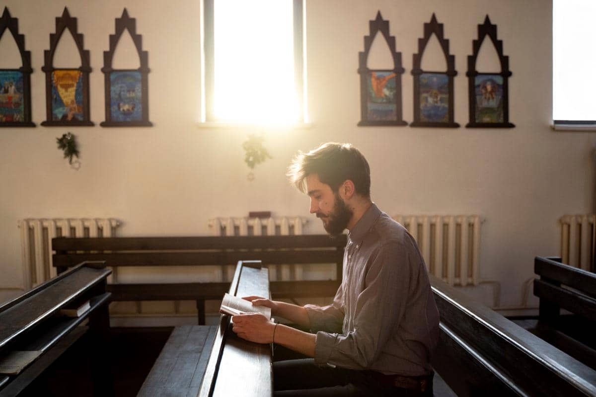 a man reading Bible in Church
