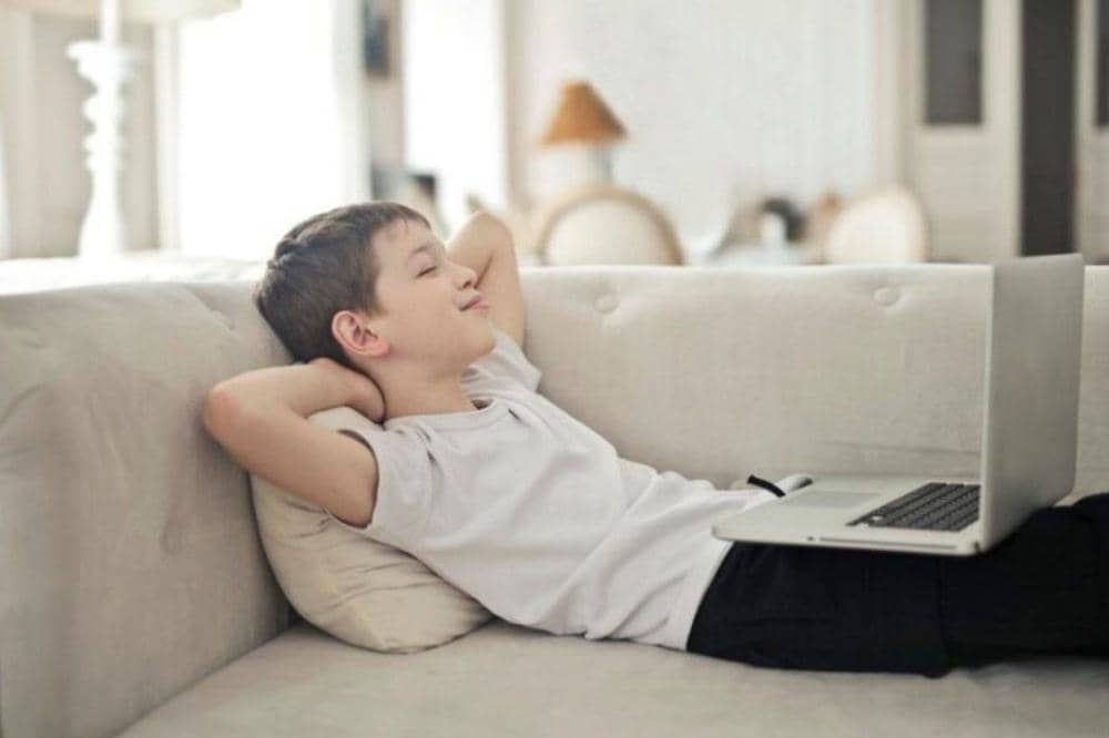 Anak sedang menjeda singkat setelah bermain laptop