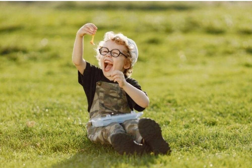 Anak tertawa dengan keras di taman