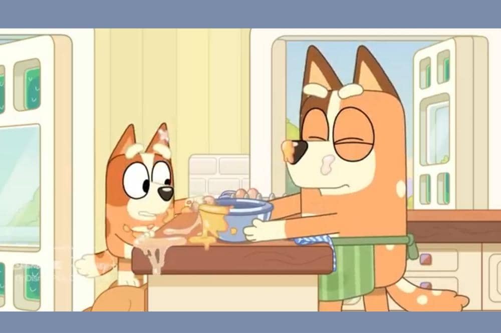 Bingo dan Chilli sedang memasak di dapur, dengan adonan tumpah di meja dan ekspresi terkejut Bingo.