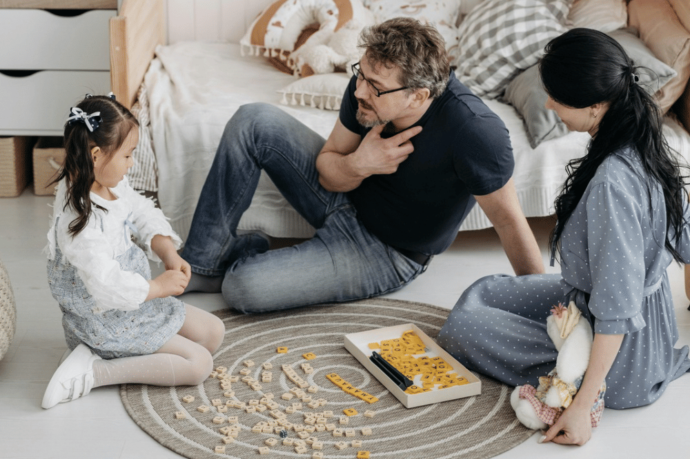 papa, mama, dan anak perempuannya sedang bercengkrama