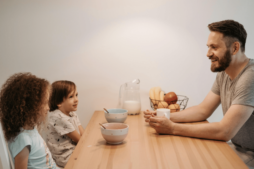 papa dan kedua anaknya sedang bercngkrama