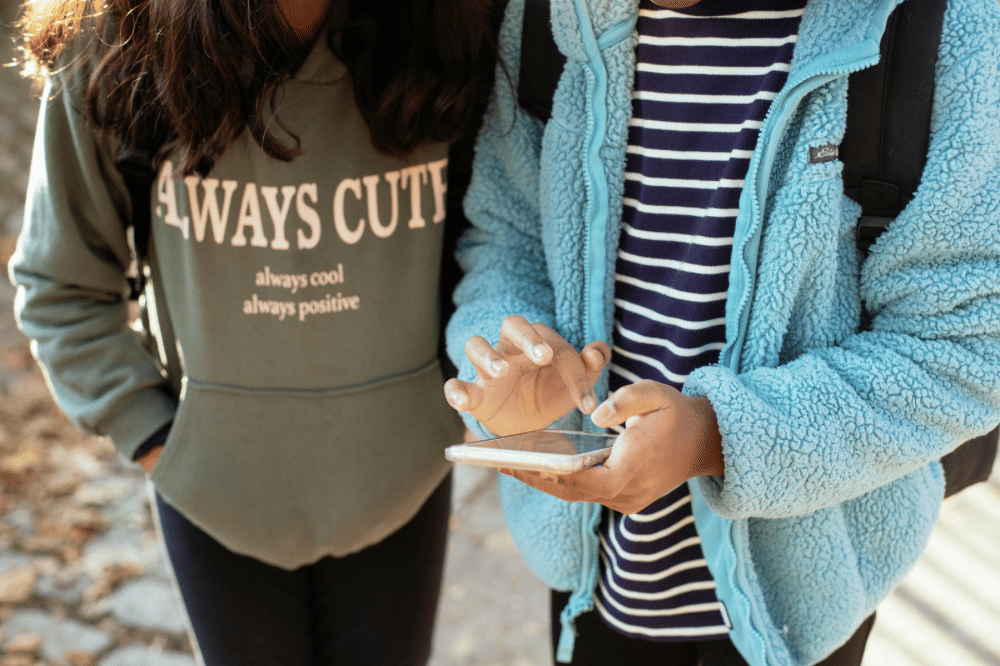 - - Pexels marytaylor httpswww.pexels.comphotomultiethnic-girlfriends-walking-on-street-with-smartphone-5896446.png
