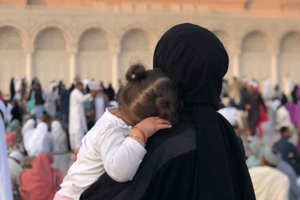 Mama menggendong sang anak saat beribadah umroh 