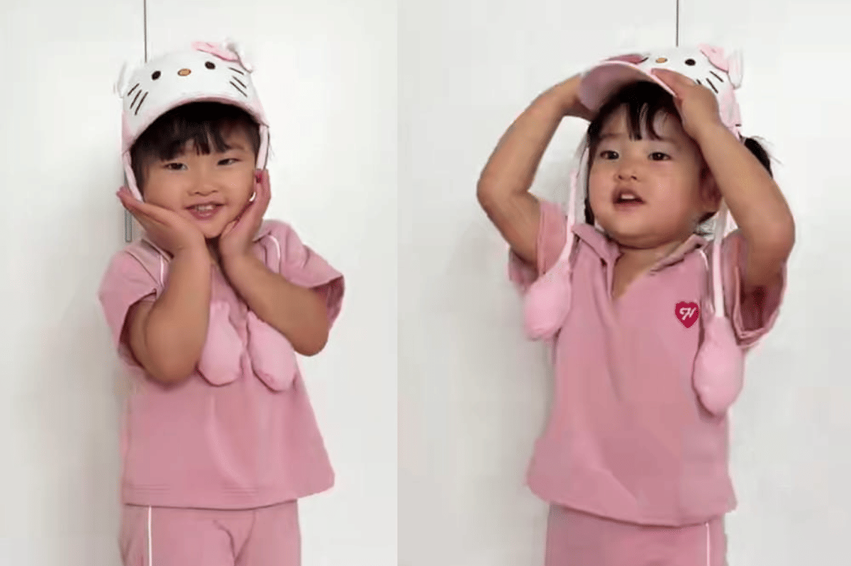 Jena terlihat seperti anak-anak seusianya dengan baju pink dan topi