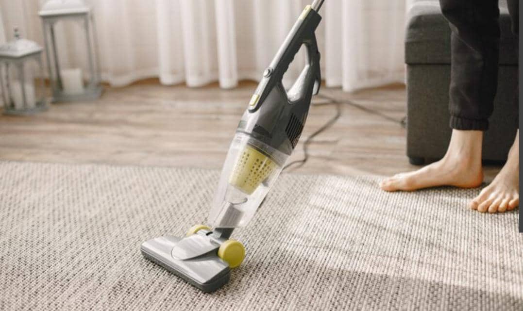 membersihkan debu dengan vacuum cleaner